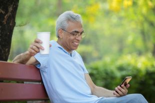 a man sitting on a bench looking happy